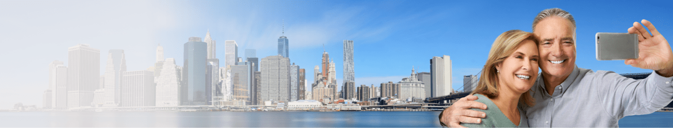 Couple taking a picture outside a city